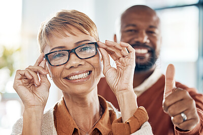 Buy stock photo Optometry, thumbs up and black woman with glasses for vision in a retail optical or eyewear shop. Happy, smile and African lady with new spectacles standing with her husband at optics clinic or store