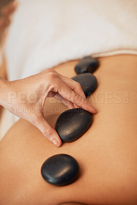 Buy stock photo Hands, rock and spa for back massage in relax for healthy wellness, zen or physical therapy treatment at resort. Hand of therapist applying rocks in relaxation, stress relief and luxury care for skin