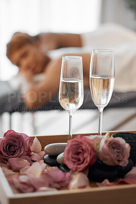 Buy stock photo Champagne, massage and couple relax together for a anniversary, love and calm spa experience. Wellness, alcohol with flowers and luxury physical therapy activity of man and woman for romance and rest
