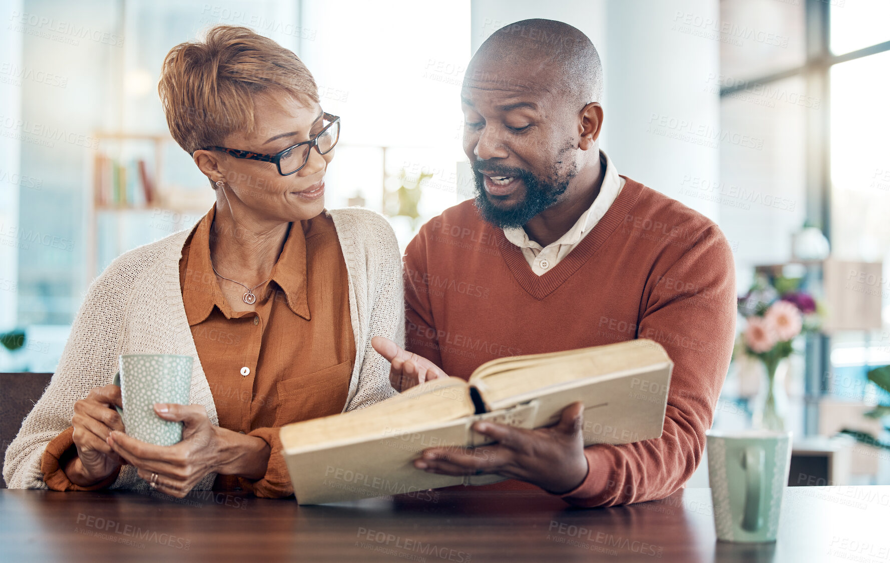 Buy stock photo Christian, prayer or black couple reading bible book for faith, worship or bible study in kitchen or living room. Coffee, happy or man and woman for education, study or black family for church Sunday