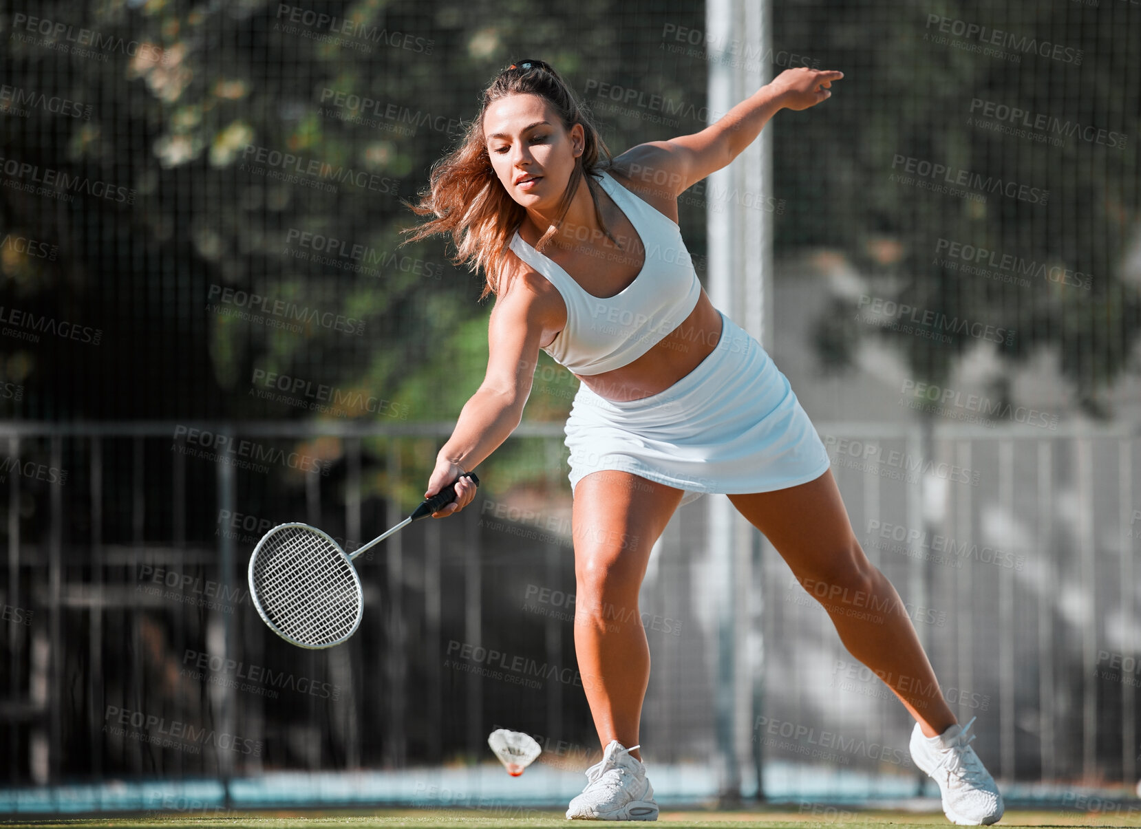 Buy stock photo Badminton, sports and woman athlete with a racket ready to swing in outdoor sport game. Young female player doing cardio exercise, match training and a wellness workout on a fitness court for health