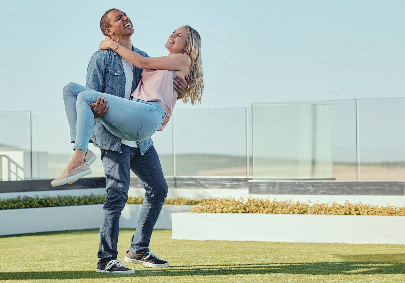 Buy stock photo Love, carrying and fun with a couple laughing or joking together outdoor in summer for bonding. Dating, happy and romance with an affectionate young man and female enjoying funny humor outside