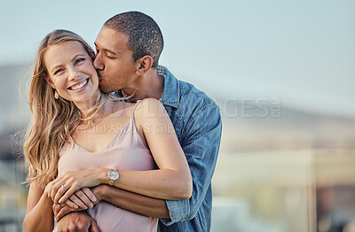 Buy stock photo Couple, kiss and smile of people with a hug together outdoor feeling love, care and happiness. Portrait of marriage, commitment and happy interracial relationship hugging and kissing for anniversary