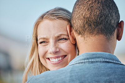 Buy stock photo Interracial couple, woman and smile on black man shoulder with happiness outdoor in summer for love. Happy, girl and man in diversity with hug, care and bonding in relationship in sunshine closeup
