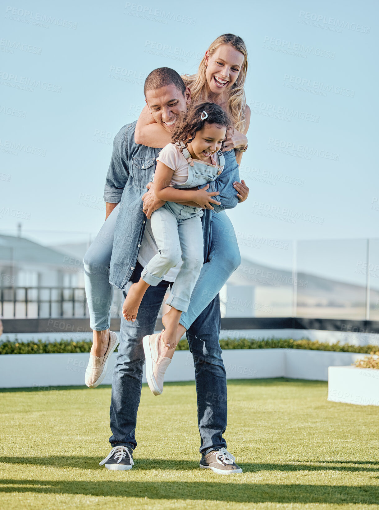 Buy stock photo Happy family, fun and parents with a girl child on a house roof in summer with a smile. Happiness, quality time and interracial family of a mother, dad and kid feeling love and care outdoor together