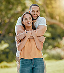 Young couple hugging in park, garden and nature for love, care and romantic date together outdoors in Colombia. Portrait of smile, laughing and relax couple in happy marriage and joyful relationship 