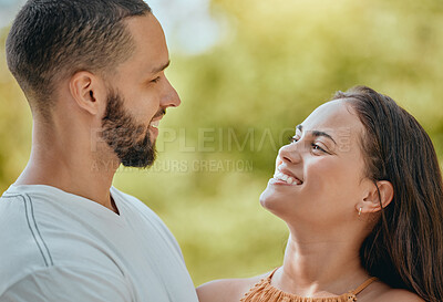 Buy stock photo Happy, smile and love with a young couple together outdoor in nature on a green background during summer. Park, romance and dating with an affectionate man and woman bonding on a sunny day in nature