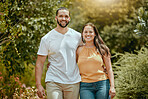 Happy, smile and portrait of a couple in a garden on a summer picnic date together in Mexico. Happiness, love and young man and woman standing in an outdoor green park on a fun adventure or holiday.