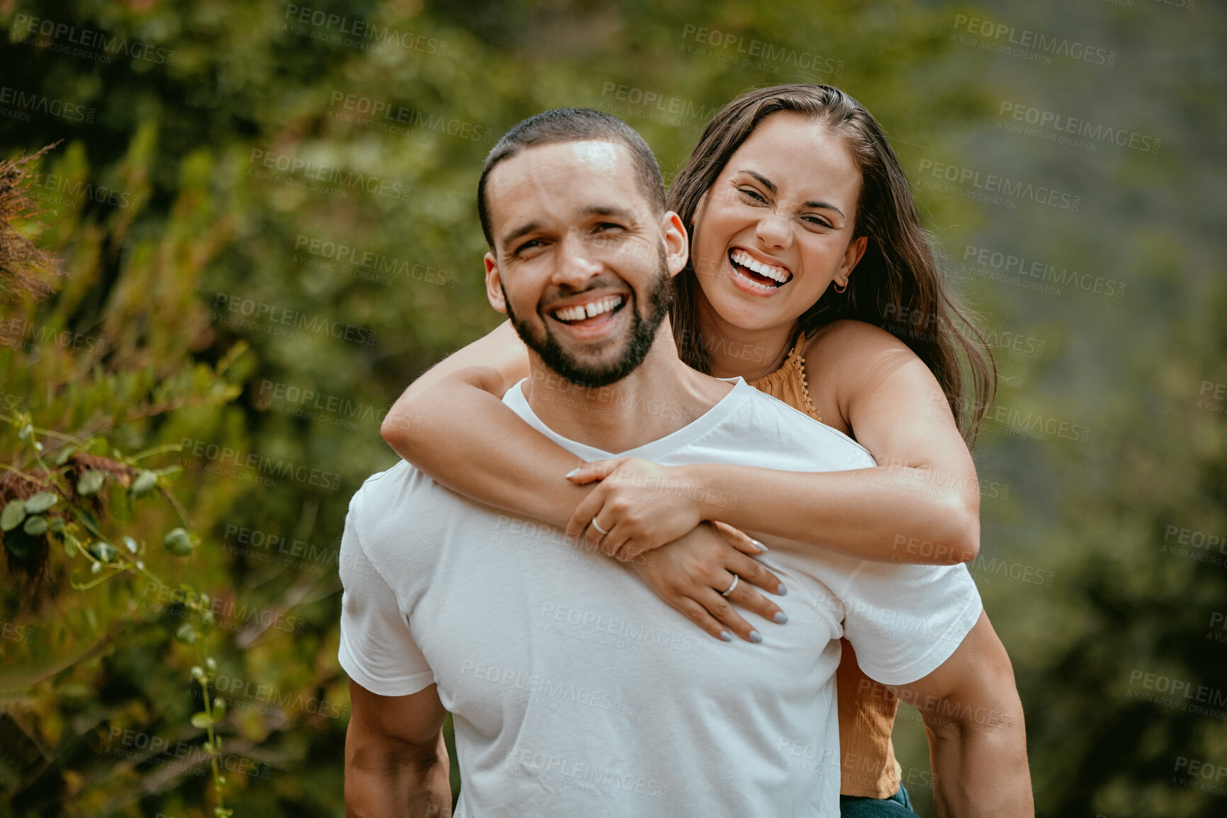 Buy stock photo Happy, couple and portrait in a park, smile and relax while having fun, cheerful and laughing in nature. Face, joy and man carry woman in a forest, excited and embracing on a peaceful summer day