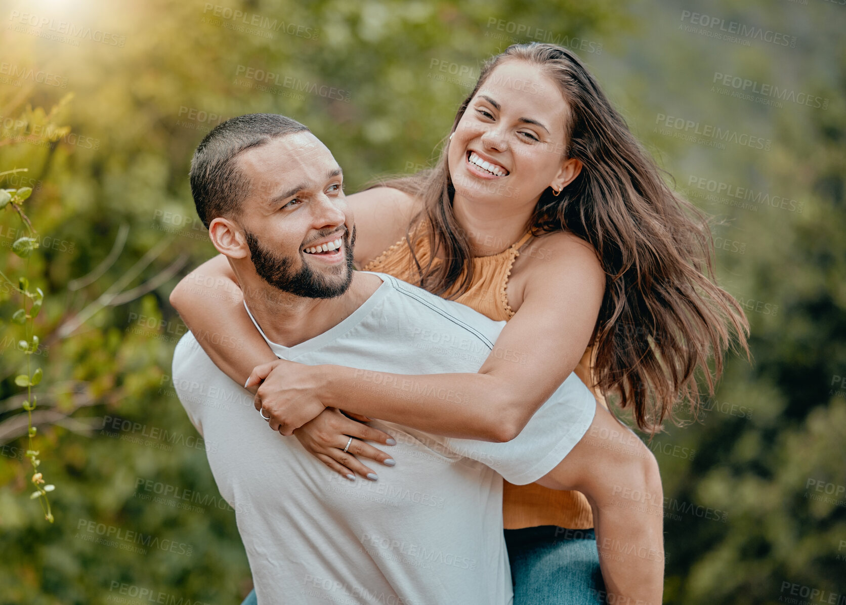 Buy stock photo Love, fun and nature couple hug while playing, happy and enjoy outdoor quality time together in Toronto Canada park. Freedom peace, partnership trust and man piggyback woman on romantic bonding date