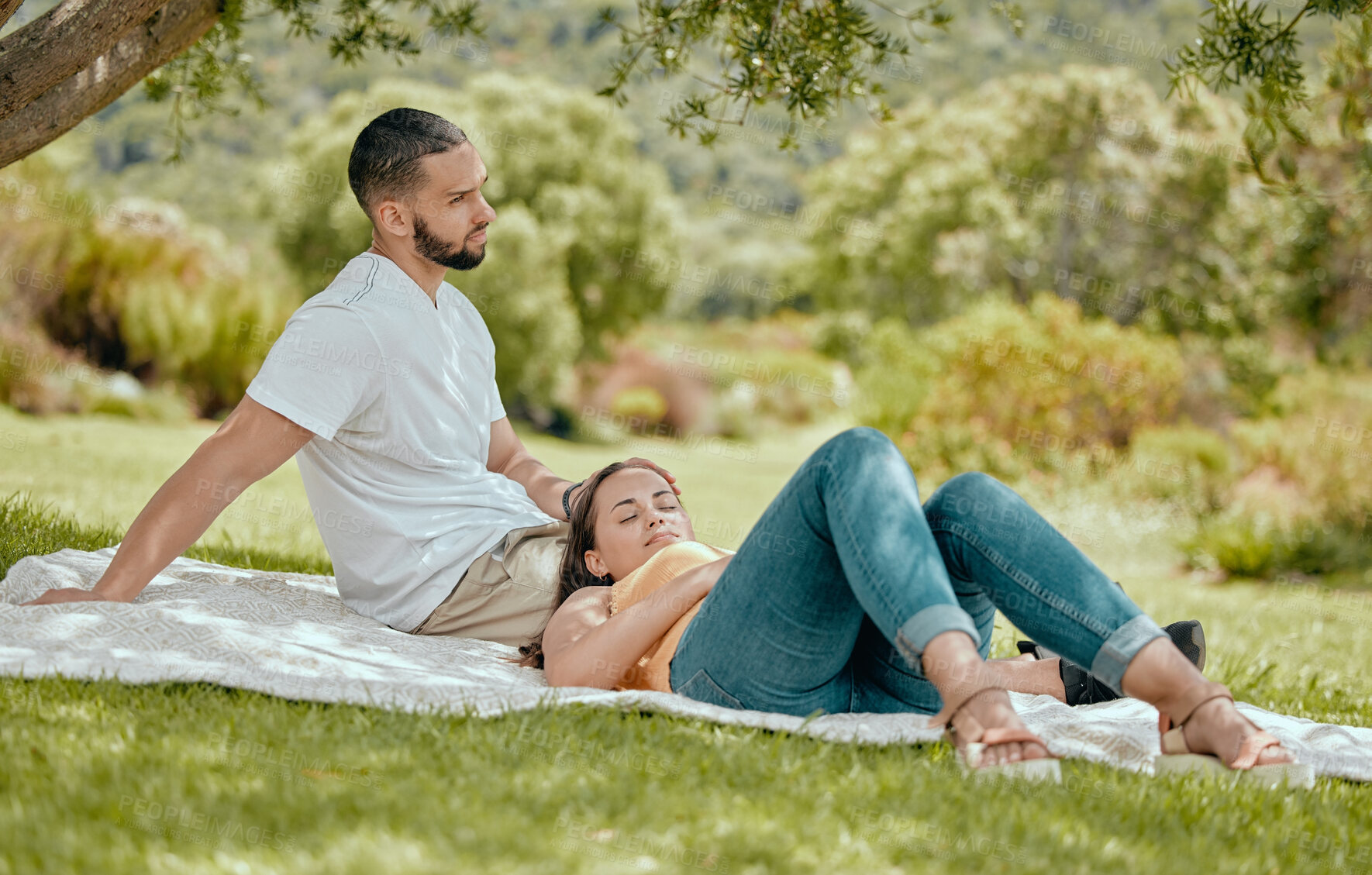 Buy stock photo Love, couple and relax on blanket in park, nature or 
outdoors bonding and resting. Romance, support and woman sleeping outside with man by tree, enjoying date or vacation time together in garden.
