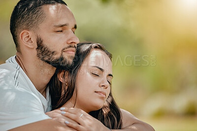 Buy stock photo Nature, love and young couple rest in park enjoying weekend, freedom and holiday together. Romance, bonding and man and woman hugging, embracing and holding each other with closed eyes outdoors