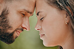 Couple, forehead and love for care, relationship or support in romance or quality bonding time together in the outdoors. Closeup of man and woman relaxing heads embracing healthy partnership outside