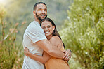 Black couple, hug and smile in woods together, outdoor and bush with love, romance or bonding on vacation in nature. Happy, man and woman embrace in portrait, forest or trees for happiness in Atlanta