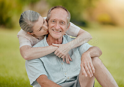 Buy stock photo Senior couple, park and kiss for love, affection and care outside in a garden in summer. Mature, retired husband and wife bonding and being loving, caring and affectionate in romantic relationship