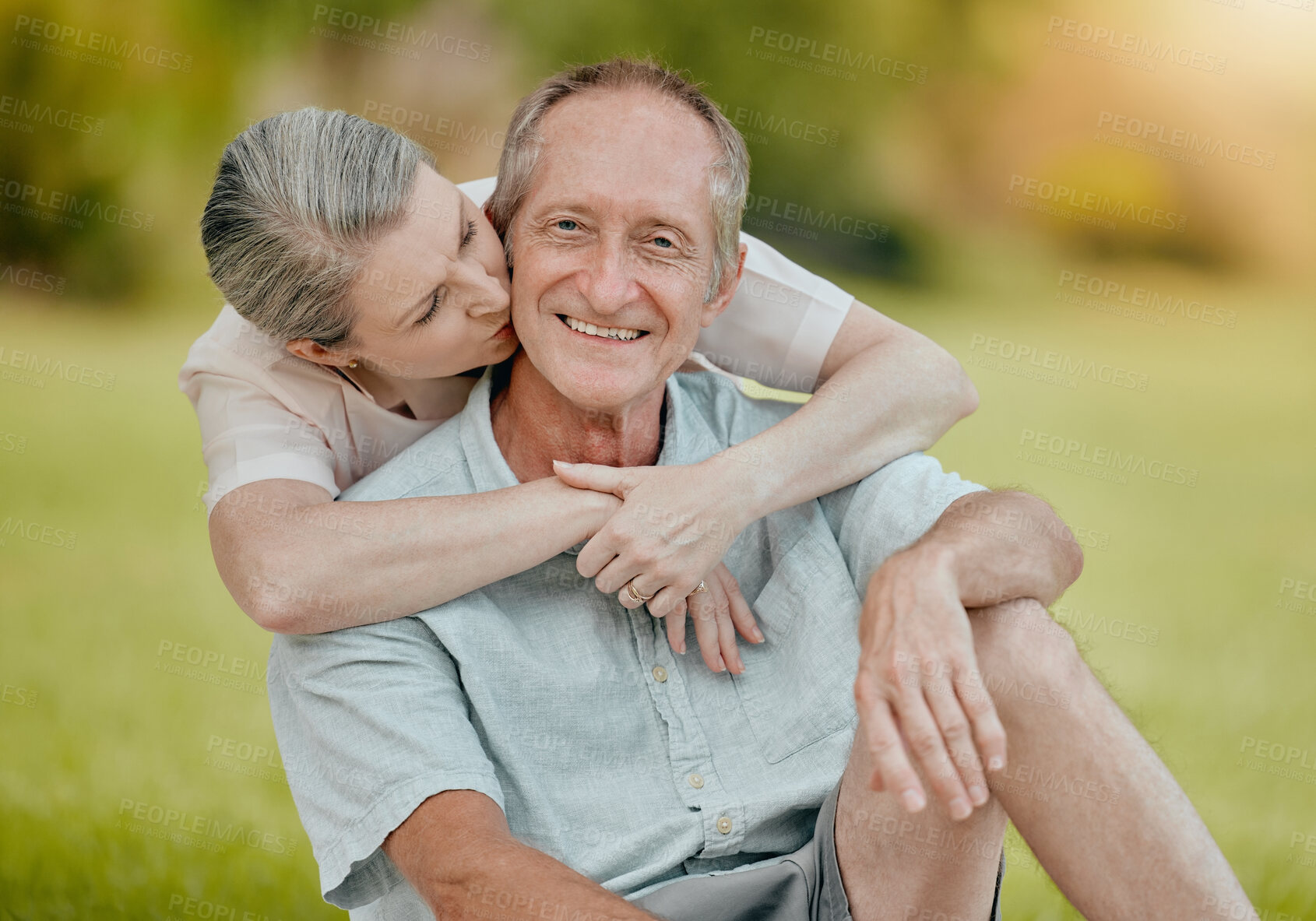 Buy stock photo Senior couple, park and kiss for love, affection and care outside in a garden in summer. Mature, retired husband and wife bonding and being loving, caring and affectionate in romantic relationship