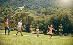 Kite, parents and children being happy, outdoor and playful for quality time together, on weekend and on vacation. Love, mother and father with kids, happiness and fun with flying toy, joy and summer