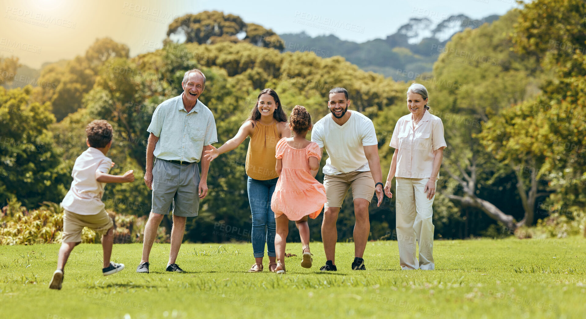 Buy stock photo Big family, nature park and happy to play with children running on grass with senior grandparents, mom and dad smile in summer sunshine. Fun mother, father and open arms to hug kids outdoors together