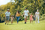 Happy family, hand holding and nature park walk with mom, dad and children with grandparents. Walking mother, kids and senior people together with love, summer fun and care spending quality time