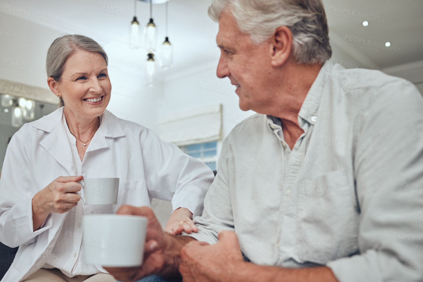 Buy stock photo Coffee, morning and love with a senior couple drinking a beverage together in the living room of their retirement home. Tea, relax and talking with a mature man and woman bonding with a drink