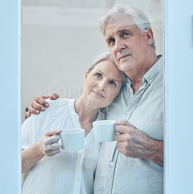 Buy stock photo Love, coffee and senior couple at a window in their home, relax and hug while looking out together. Glass, family and mature man and woman drinking tea, enjoying retirement and view from their house