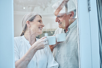 Buy stock photo Love, coffee and window with senior couple relax, laugh and bond while looking cozy, happy and drinking coffee in their home. Glass, tea and elderly people enjoy retirement, quality time and rest