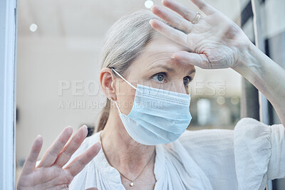 Buy stock photo Lonely, senior woman in covid quarantine for prevention, protection and being depressed with mask. Elderly female, face cover and looking outside window frustrated, sadness and isolation for corona.