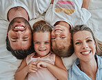 Happy family, love and morning smile with parents and children lying and happy in bedroom for fun together at home from above. Laugh and man and woman love, care and happiness with girl kids to bond
