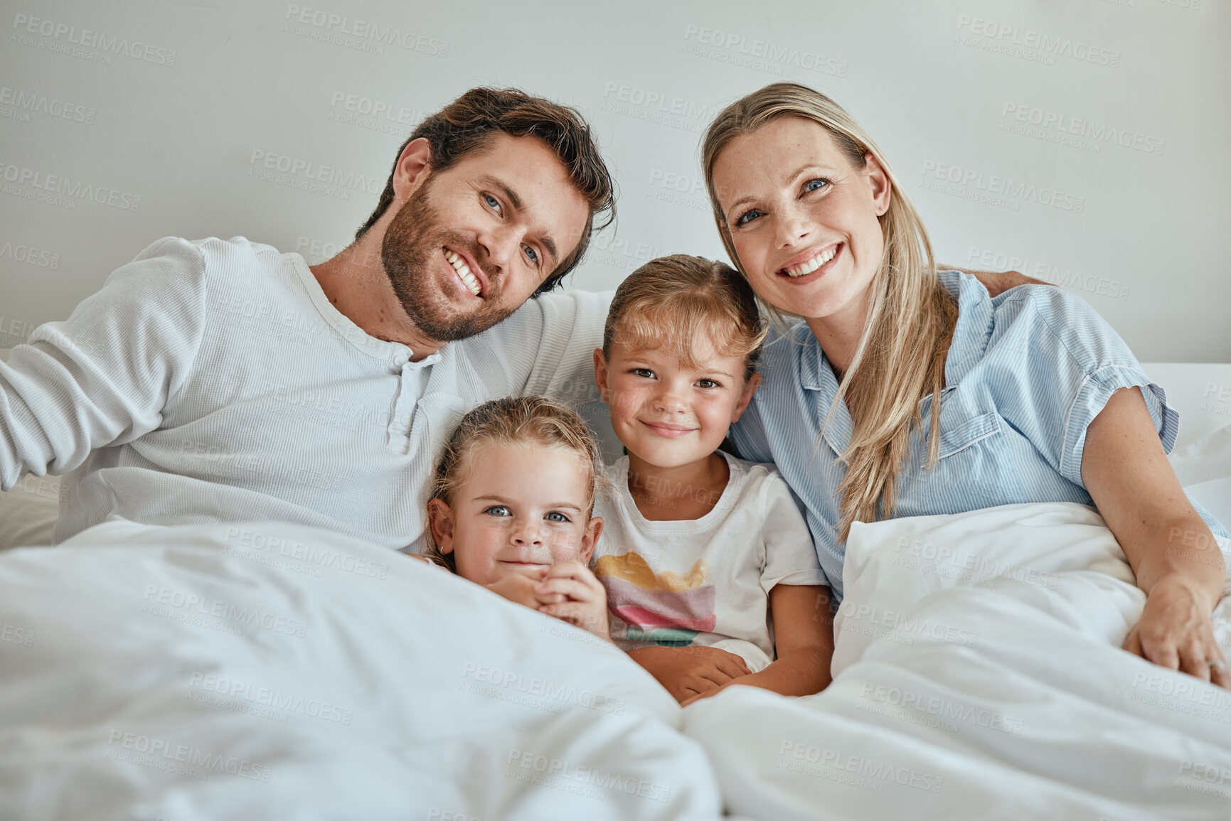 Buy stock photo Relax, happy and portrait of family in bed in the morning for wake up, support and quality time together. Smile, peace and weekend with parents and children at home for bonding, connection and care