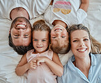 Top view, family and portrait in bedroom home, bonding or having fun. Love, care and happy kids or girls, mother and father enjoying good time together, smiling or laughing while relaxing in house.
