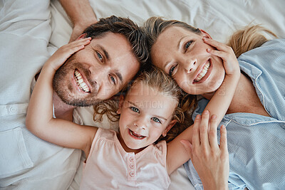 Buy stock photo Happy, relax and portrait of family in bed with top view for wake up, support and smile together. Peace, bonding and connection with parents and girl lying at home for weekend, care and lifestyle