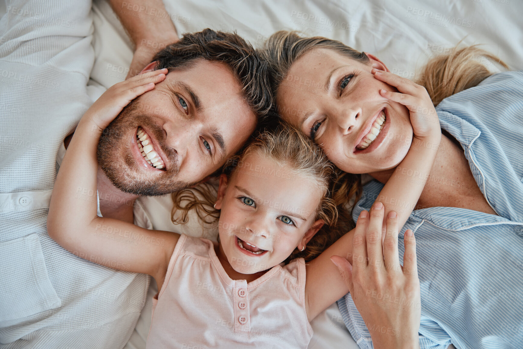 Buy stock photo Happy, relax and portrait of family in bed with top view for wake up, support and smile together. Peace, bonding and connection with parents and girl lying at home for weekend, care and lifestyle