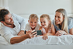 Family, bedroom and selfie for bonding and love while at home with a smartphone. Bed, phone and photo of happy parents relaxing in together for affection, loving and caring relationship in home