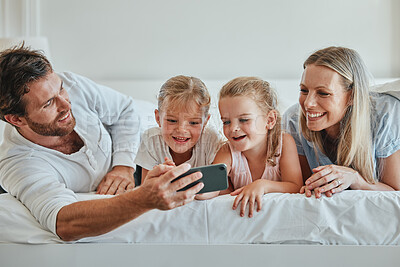 Buy stock photo Family, bedroom and selfie for bonding and love while at home with a smartphone. Bed, phone and photo of happy parents relaxing in together for affection, loving and caring relationship in home