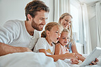 Tablet, children and family in bed with a mother, father and daughter siblings streaming online content together at home. Technology, kids and love with a man, woman and girl sisters watching series 