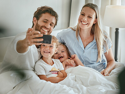 Buy stock photo Phone selfie, family and relax in bed together bonding, smiling for mobile photograph for social media. Happy parents, excited smiling children and digital tech smartphone in bedroom at home