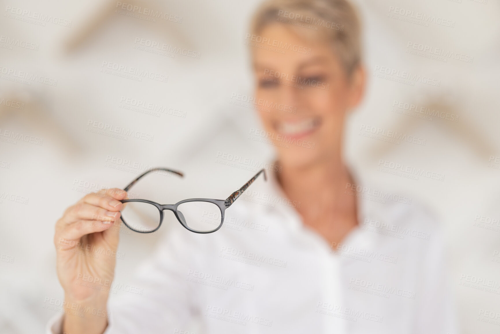 Buy stock photo Vision, blur and woman holding glasses in an optometry store buying prescription lenses. Retail, optometrist and senior lady trying spectacles in optician, optical or eyewear shop for eye care.