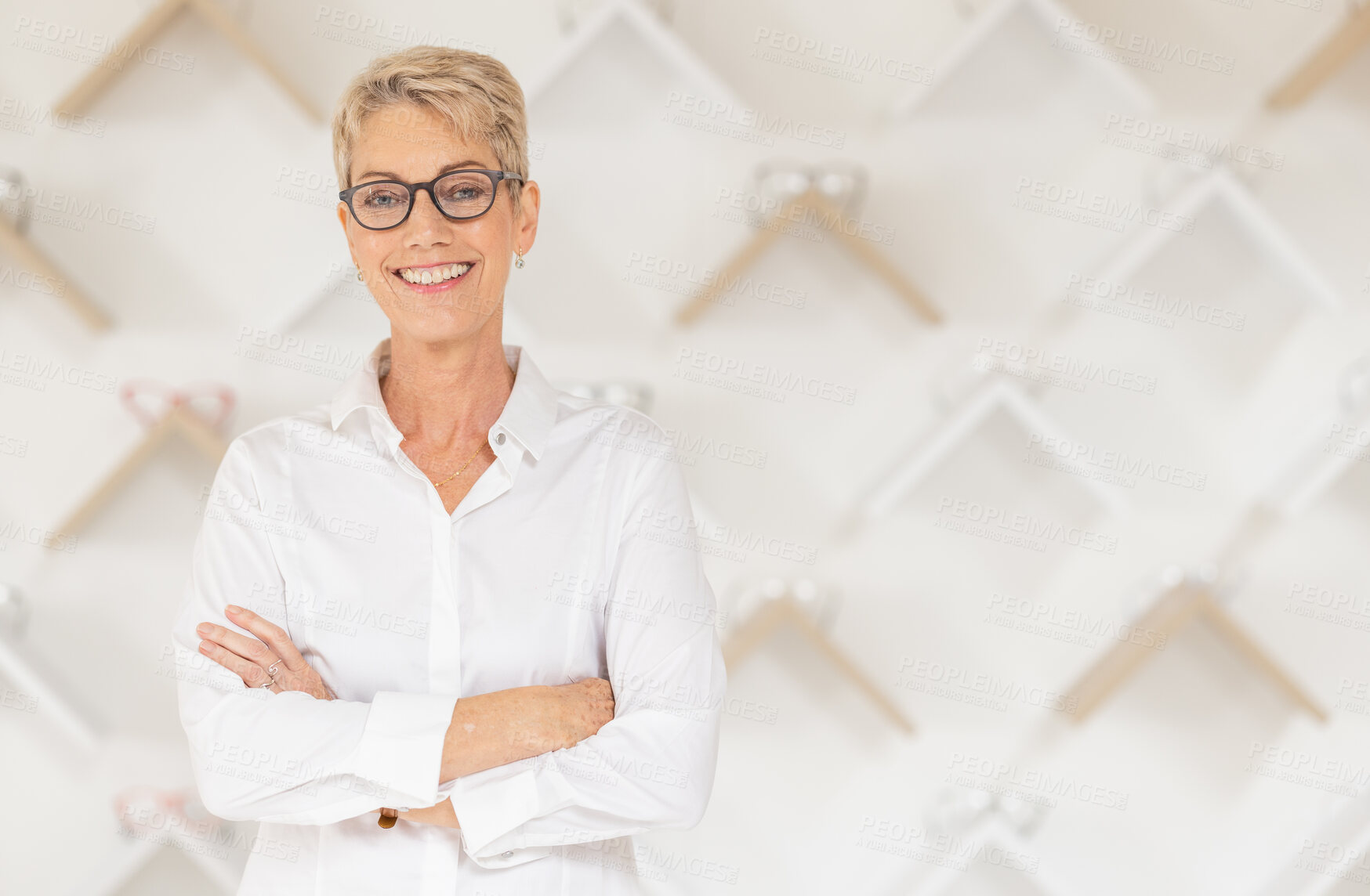 Buy stock photo Portrait, glasses and vision with a woman optometrist standing arms crossed alone in her optometry store. Ophthalmology, eyewear and frame with a mature female optician selling frame lenses