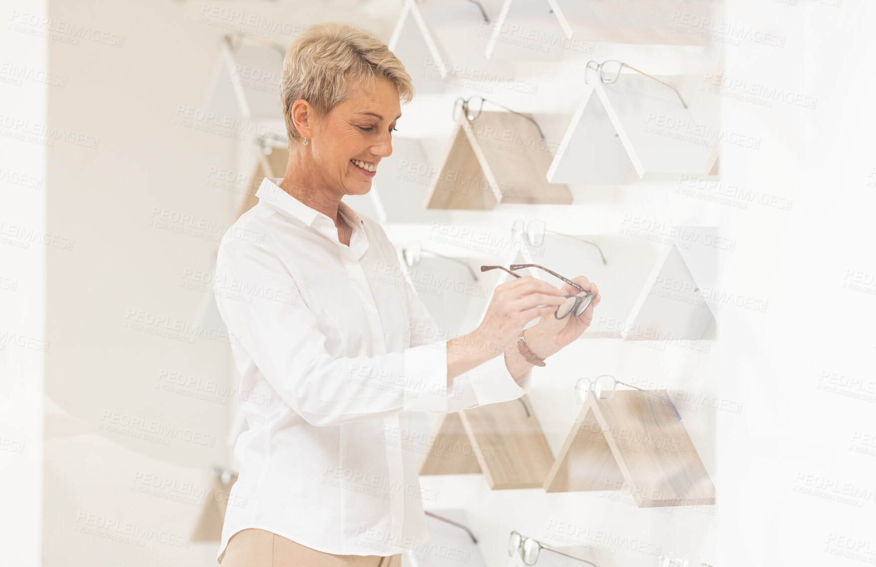 Buy stock photo Optometry, shopping and senior woman choosing a new frame at a modern retail eyewear store. Vision, eyesight and elderly lady in retirement picking spectacles for a prescription lens in optical shop.