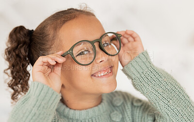 Buy stock photo Face portrait, child and girl with glasses for optical health at optometrist office. Eyes wellness, eye care and happy kid with specs, spectacles or prescription lenses to help with ocular vision.