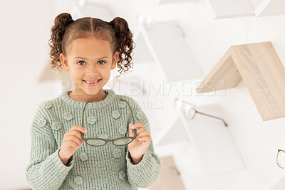 Buy stock photo Girl, child and glasses for vision, shopping and buying spectacles in an optometry store. Retail, choice and eyewear for small kid choosing eyeglasses for eyesight and opthalmology 