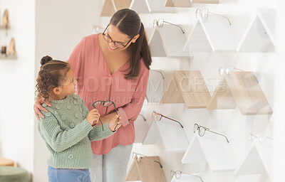 Buy stock photo Glasses, vision and mother with child in optometry shop with choice or decision for design, frame and product happy with family health insurance. Mom and kid customer with eye care help and support