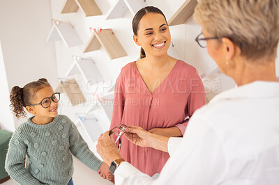 Buy stock photo Happy mother, child and and optometrist with glasses eye exam for eyesight, eyes wellness and healthy vision. Girl with mother, eyecare store and shopping eyewear, spectacles or prescription lenses 
