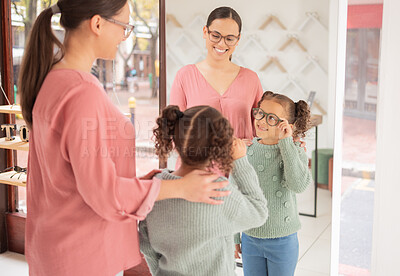 Buy stock photo Retail, eye care and mother and daughter shopping for glasses at optician store, happy and relax while bonding and having fun. Optometry, vision and child excited while choosing a frame for eyewear