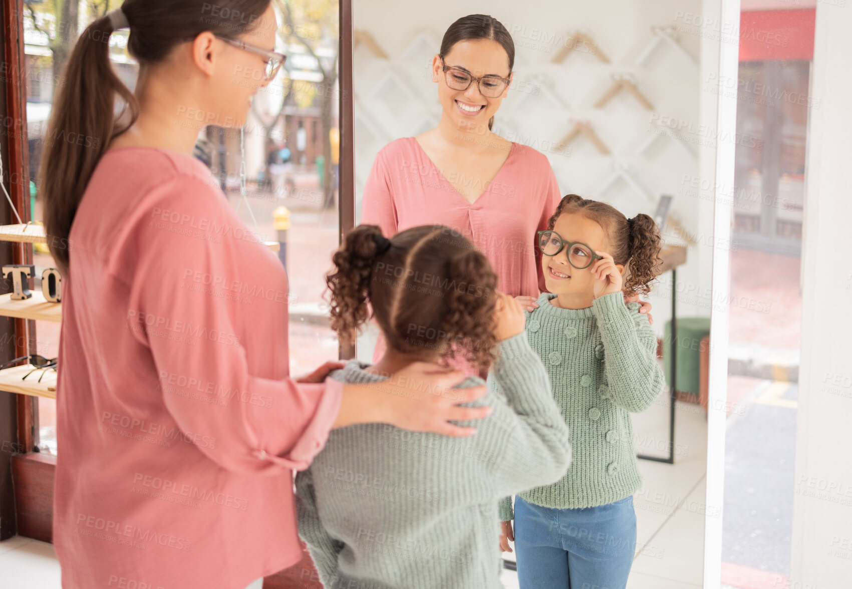 Buy stock photo Retail, eye care and mother and daughter shopping for glasses at optician store, happy and relax while bonding and having fun. Optometry, vision and child excited while choosing a frame for eyewear