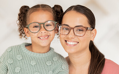 Buy stock photo Mother, girl and glasses in optometry shop, frame and happy after shopping in retail store with smile for vision result. Portrait of latino mom, child and happiness with optical lense at optometrist 