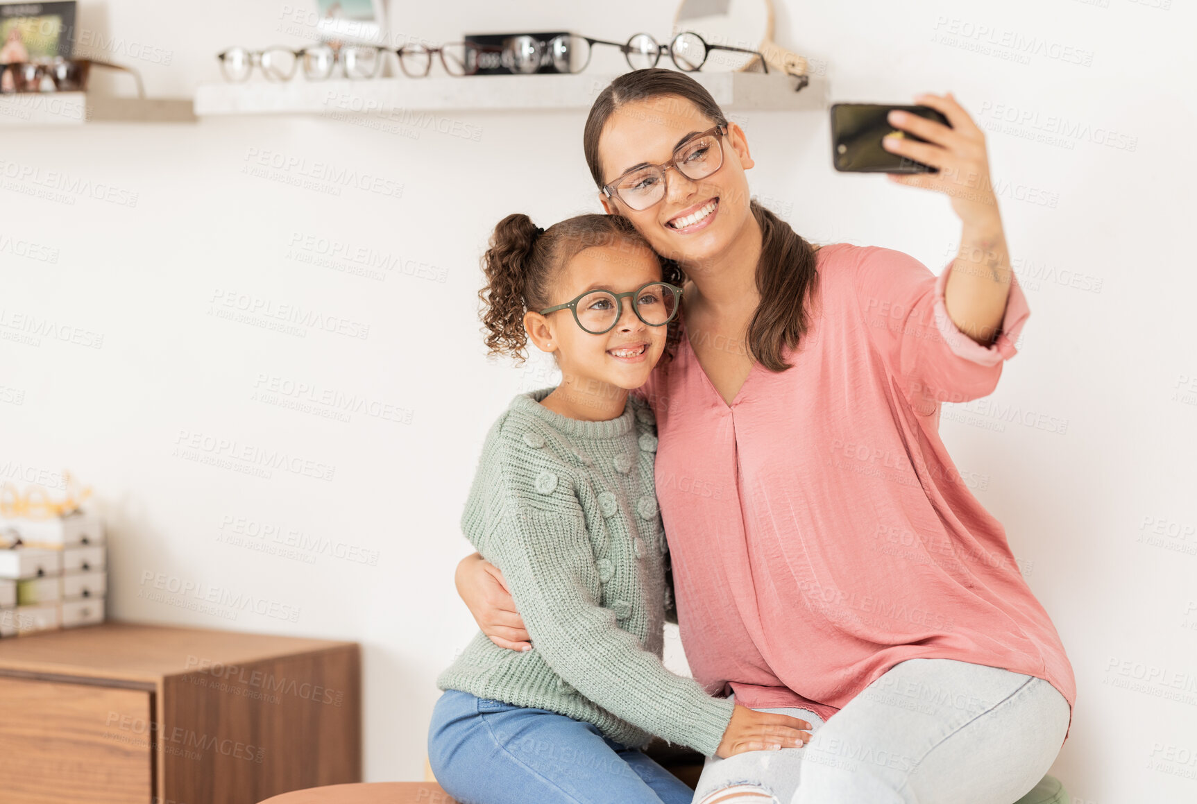 Buy stock photo Mother, girl and phone selfie at optometrist, glasses and smile for eye vision, eyesight and social media picture for new lense frame. Woman, child and happy with eyeglasses or 5g mobile smartphone