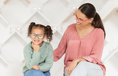Buy stock photo Shopping, vision and glasses with mother and girl buying eyewear together in retail store. Woman, daughter and consumer optics while buy eyeglasses in optometry shop for eye health and eye care 