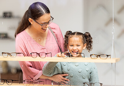 Buy stock photo Decision, glasses and girl with her mother at the optometrist for vision and check on eyes together. Customer, medical and child shopping for eyeglasses with her mom at the ophthalmologist clinic