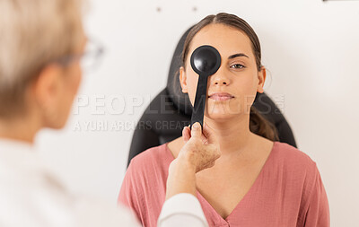 Buy stock photo Woman, eye exam and vision test with occluder at optometrist for eyesight, glasses or checkup at the clinic. Doctor optician helping female patient eyes for optical sight in examination or testing